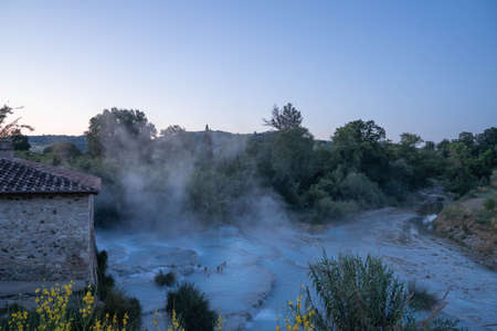 Saturnia, Italy - June 24, 2020, Four young man taking bath in natural spa with waterfalls and hot springs at  thermal baths in Saturnia, Tuscany in  Italyのeditorial素材