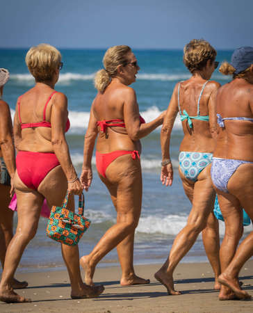 Bufalara, Italy - August 26, 2020, Groups of women on the beach without masks do not maintain social distance. Second wave of coronavirus in Italy (covid19)のeditorial素材