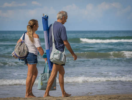 Bufalara, Italy - Septembre 02, 2020, Man and woman going along the beach. Second wave of coronavirus in Italy (covid19)のeditorial素材