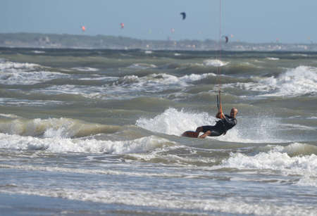 Marina di San Nicola, Italy - October 04, 2020, Kiter in the stormy sea on the beach of Marina di San Nicola in Italyのeditorial素材