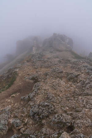 Image of ruins of medieval castle in clouds and fog in Rocca Calascio, Abruzzo, Italy