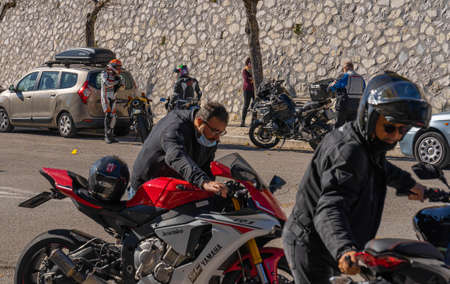 Orvinio, Italy - October 31, 2020, Masked and unmasked traveling bikers who stop to eat in Italian Borgo Orvinio during second wave of coronavirus (Covid19), non-observance of social distance in Italyのeditorial素材