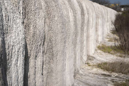 White limestone deposits on an aqueduct carrying thermal water from spring to pool at Baths of...
