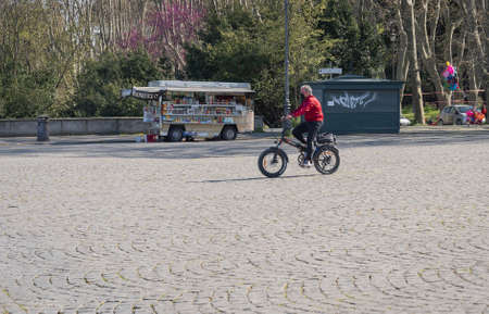 Rome, Italy - March 28, 2021, Man wearing a black mask in a square during the pandemic (Covid2019)...