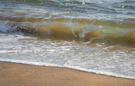 Colored sea waves with splashes and white breakers in Circeo park in Sabaudia in Italy
