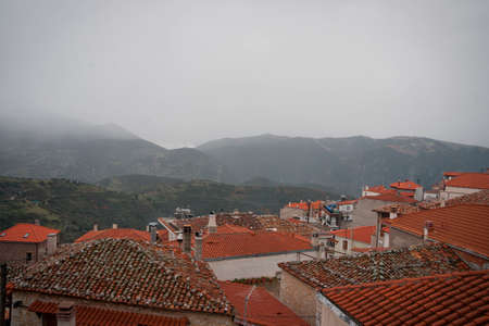 Cityscape with roofs in fog on the streets of Arachova village in Greece