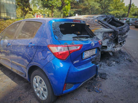 Rome, Italy - August 19, 2021, Remains of two burnt passenger cars on the street of Rome, Italyのeditorial素材