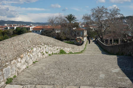 Arta, Greece - March 08, 2014, People on medieval bridge over river Arahthos in Arta, Greeceのeditorial素材