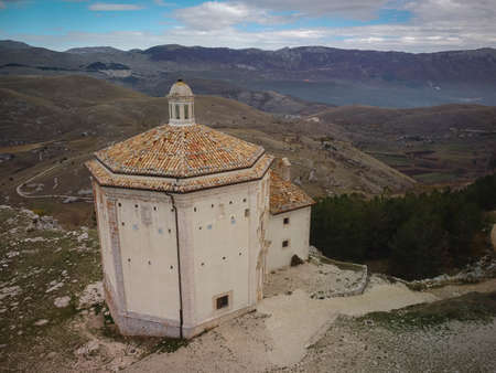 Aerial view of ruins of medieval chapel in Rocca Calascio and autumn mountains of Abruzzo in Italyの写真素材