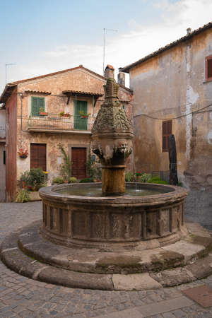 Medieval fountain in square in town of Sutri in Lazio in Italyの写真素材