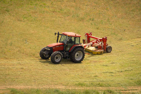 Rome, Italy - May 05, 2020, Small tractor working in a field on the outskirts of Rome, Italy