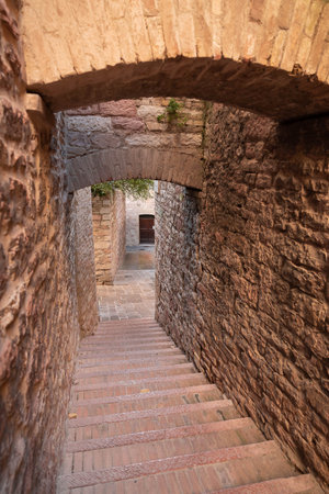 Picturesque cityscape in the pink stone city of Assisi in Perugia in Italyの写真素材