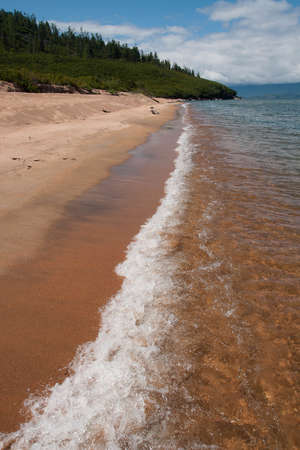 Image of sandy shore and oncoming wave on Lake Baikal in Irkutsk region in Russiaの写真素材