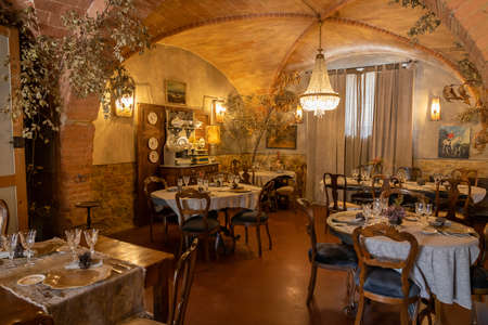 Ancient room with vaults, beautiful furniture and festive tables, Tuscany in Italyの写真素材