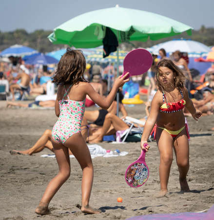 Marina di San Nikola, Italy - September 05, 2021, Family playing ball on the beach in Marina San Nicola in Italyのeditorial素材