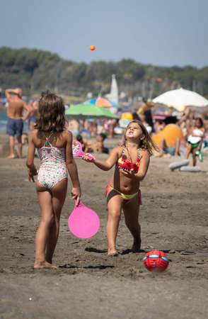 Marina di San Nikola, Italy - September 05, 2021, Family playing ball on the beach in Marina San Nicola in Italyのeditorial素材