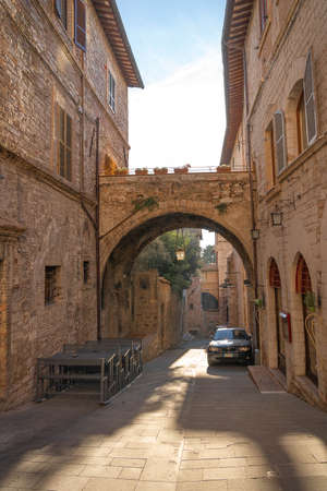 Assisi, Italy - November 20, 2021, Picturesque cityscape in the pink stone city of Assisi in Perugia, Italyのeditorial素材