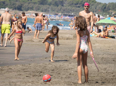 Marina di San Nikola, Italy - September 05, 2021, Family playing ball on the beach in Marina San Nicola in Italyのeditorial素材