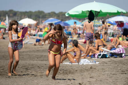 Marina di San Nikola, Italy - September 05, 2021, Family playing ball on the beach in Marina San Nicola in Italyのeditorial素材