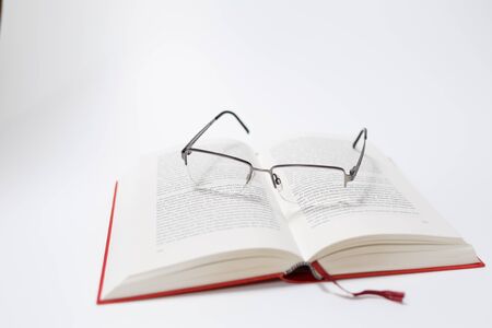 Glasses and book isolated on white Backgroundの写真素材