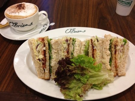 O briens classic triple decker with cup of capuccino. Photo taken from an outlet in Malaysia.の素材