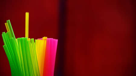 pink, yellow and green plastic drinking straws