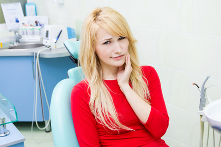 Closeup portrait sad woman with painful toothの写真素材