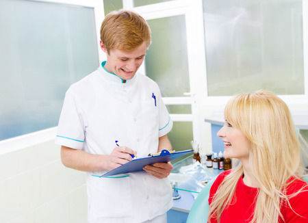 Closeup portrait happy, smiling female patient, woman sitting in chairの写真素材
