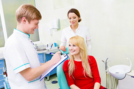 Closeup portrait happy, smiling female patient, woman sitting in chairの写真素材