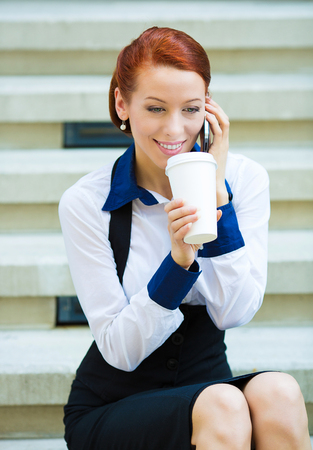 Portrait happy smiling businesswoman talking on mobile cell phoneの写真素材
