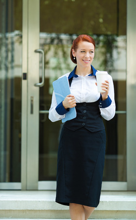 Portrait attractive young business woman leaving her corporate officeの写真素材