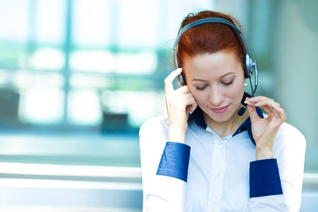 Closeup portrait business woman, serious customer service representative call centre worker operatorの写真素材