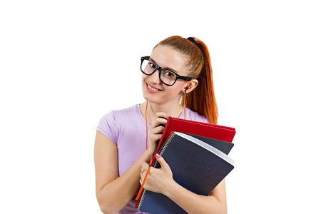 Closeup portrait young smart  woman with glasses, holding books, listening to music, prepared, ready to take her test finals, isolated white background. Positive facial expressions, feelings, emotionsの写真素材