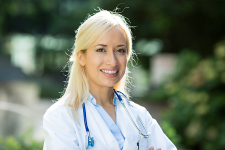 Closeup portrait young smiling confident female doctor healthcare professional with stethoscope=の写真素材