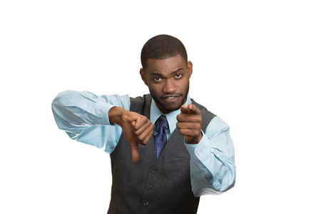 Closeup portrait unhappy, angry, mad, executive man, annoyed, giving thumbs down gesture, pouting at you with finger looking with negative facial expression, disapproval, isolated white background.の写真素材