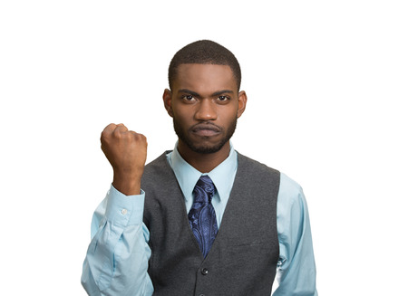 Closeup portrait angry cranky, upset, pissed off young man, worker, business employee putting up fist ready to give knuckle sandwich isolated white background. Negative emotion facial expression feelingの写真素材