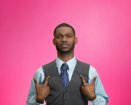 Closeup portrait angry, unhappy annoyed, rude young executive man, getting mad asking question you talking to, mean me? Isolated pink background. Negative emotion facial expression feeling attitudeの写真素材