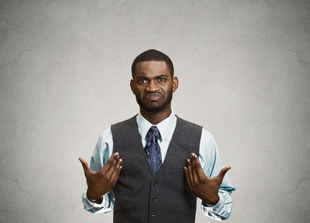 Closeup portrait surprised, angry, mad, unhappy, annoyed young executive man, asking question: you talking to, mean me? Isolated grey color background. Negative human emotion, facial expressionの写真素材