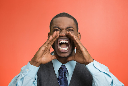 Closeup portrait bitter mad, displeased pissed off, angry grumpy corporate man, open mouth, hands in air, screaming, yelling isolated red background. Negative human emotion facial expression feelingの写真素材
