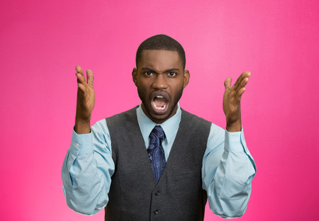 Closeup portrait bitter mad, displeased pissed off, angry grumpy corporate man, open mouth, hands in air, screaming, yelling isolated pink background. Negative human emotion facial expression feelingの写真素材
