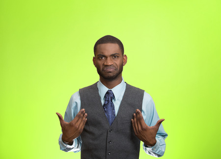 Closeup portrait surprised, angry, mad, unhappy, annoyed young executive man, asking question: you talking to, mean me? Isolated green color background. Negative human emotion, facial expressionの写真素材