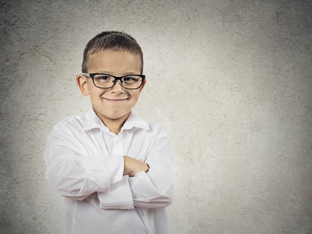 Closeup portrait standing, smiling little Boy, happy young man with hands folded, isolated grey, black background copy space Positive human emotions, face expressions, life perception, body languageの写真素材