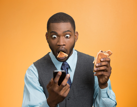 Portrait surprised, funny looking, corporate business man holding, reading bad news on smart phone,...