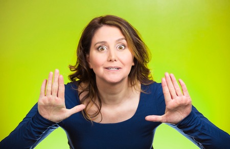 Portrait cautious, afraid, annoyed displeased young woman raising hands up to say no, stop right...