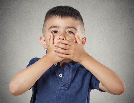 Closeup portrait young handsome man, boy closing, covering mouth with hands canの写真素材
