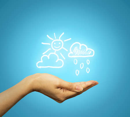 Closeup woman hand with weather iconsの写真素材