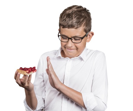 Carbs cravings. Portrait teenager boy craving cake confused funny looking man trying to withstand resist temptation to eat sweet tart isolated white background. Facial expression emotion reactionの写真素材