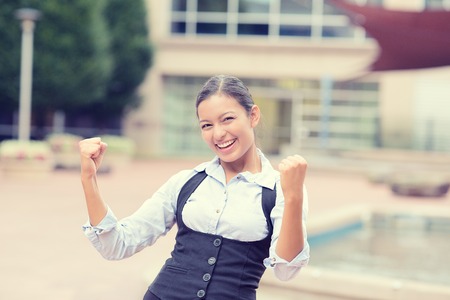 Portrait winning successful young business woman happy ecstatic celebrating being winner victory isolated outside background.の写真素材