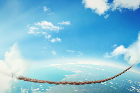 Managing risk big business challenges uncertainty concept. Walking on dangerous rope high in sky...