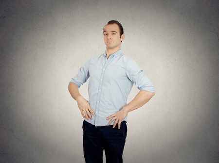 Closeup portrait arrogant aggressive bold self important uppity stuck up man with napoleon complex short man syndrome isolated grey wall background. Human emotion facial expression feeling perceptionの写真素材